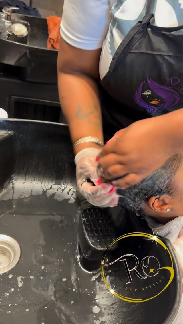Stylist washing a client's hair at the bowl, DiVine Stylez apron